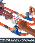 Hands using slam-launchers on Hot Wheels RacerVerse Spider-Man Web-Slinging Speedway Track Set With Spider-Man And Black Panther Epic Multi-Lap Race From Slam-Launchers To Outspeed Doc Ock Kids Zoom Through The Web Of Action.