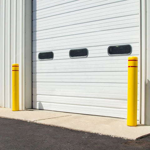 High Density Polyethylene Safety Bollard Covers Refresh Rusty Outposts With Zero Sweat Installation Plus Included Foam Pad For A Snug Setup Blocks Scratches On Pavement While Keeping The Area Looking Clean Without Any Extra Drama Year Round. Yellow bollard covers near a garage door.