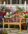 Foldable Outdoor Eucalyptus Wood Bench for Two in garden setting with flowers and white fence