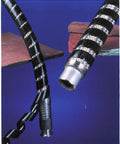 Black Polyethylene Spiral Wrap Sleeve For Wires And Cables Heavy Duty Half Inch Outer Diameter 25 Foot Spool shown wrapping cable.