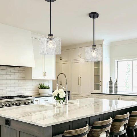 BOKUNOFU Glass Pendant Light Kitchen Island, Modern Black Pendant Light with Hammered Glass Shade over white kitchen island countertop.