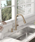 Image of Sharp Looking Champagne Gold Kitchen Faucet With Pull Down Sprayer And Single Handle Mixer over a stainless steel sink.