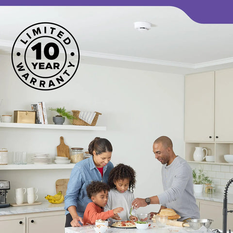 Family cooking together under a Premium Smoke And Carbon Monoxide Detector Hardwired With Aa Battery Backup 3 Pack in kitchen.