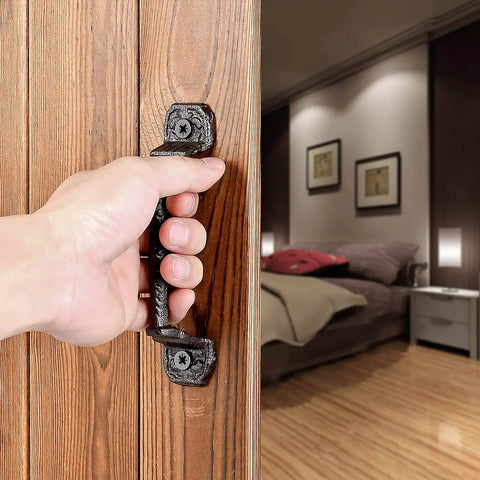 Hand opening a door with Four Pack Cast Iron Sliding Barn Door Handles 5.51 Inch Dark Brown Vintage Metal Pulls for interior use