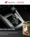 ATF Type HK Automatic Transmission Fluid For Hyundai And Kia SP III Spec 5 Quart Bottle shown next to car gearbox