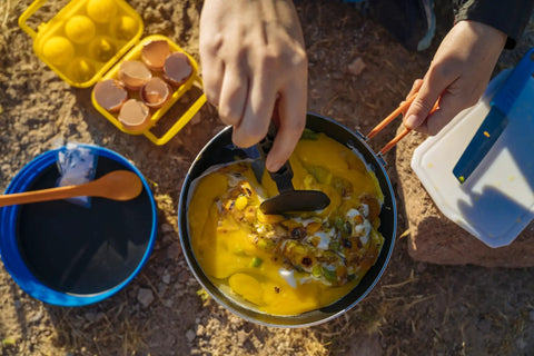 Cooking eggs in Summit Skillet Nonstick Camping Cookware For Backpacking Stoves, Ceramic Coated Aluminum Pan With Nestable Turner
