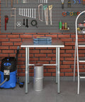 24 Inch By 30 Inch Heavy Duty Stainless Steel Work Table With Open Base For Commercial Kitchens And Garage Workshops, tools, and vacuum.