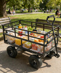 Heavy Duty Steel Dump Cart With 600 Lb Capacity Utility Wagon And Inflatable Ten Inch Tires loaded with picnic supplies in park