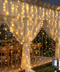 900 LED Outdoor Curtain Lights With Remote on a gazebo, providing warm white glow, ideal for wedding decor, 9.5 by 29.5 feet coverage