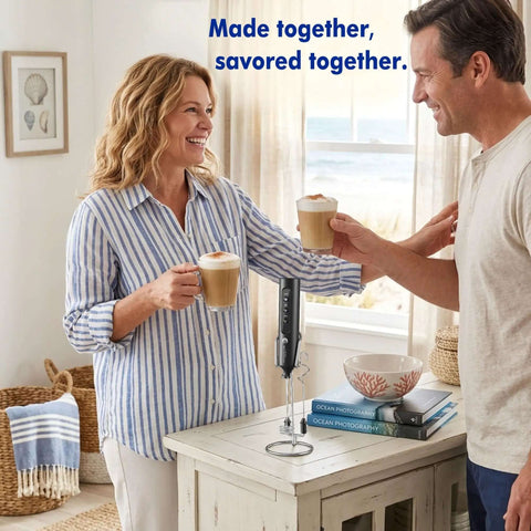 Rechargeable Milk Frother Set With Stand Battery Included Level Up Your Coffee Game Featuring 4 Swappable Whisks And Compact Travel Case in a kitchen with two people enjoying coffee.