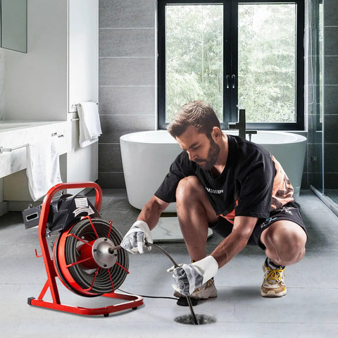 Heavy Duty Electric Drain Auger Kit With Cutter And Anti Slip Glove in action clearing a stubborn clog in pipes.