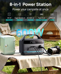 Portable Power Station 600W With 80W Solar Panel 288Wh LiFePO4 Battery on picnic table with minifridge and camera outdoors.