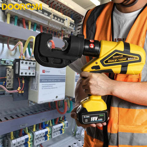 Pro-Gear Heavy Duty Electric Hydraulic Cable Lug Crimping Tool 12-Ton Battery Operated Connector in use at a wiring panel.