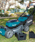 Badass 36V Brushless Cordless Self Propelled Commercial Lawn Mower with 21 Inch Steel Deck and battery pack in garden.