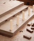 Wooden Dowel Pins Pack Of 120 Three Eighths Inch By One And A Half Inch Straight Grooved Pins With Beveled Ends on wood surface