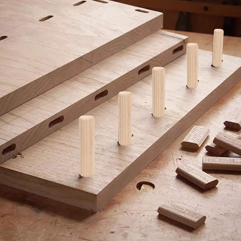 Wooden Dowel Pins Pack Of 120 Three Eighths Inch By One And A Half Inch Straight Grooved Pins With Beveled Ends on wood surface