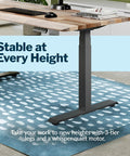 Heavy Duty Dual Motor Electric Standing Desk With Smooth Height Adjustment And Killer Ergonomic Wrist Relief Edge Built On A Solid Frame With Top Shelf Reclaimed Wood Top In Slate For Home Office with 3-tier legs.