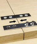 Close-up of two Heavy Duty Galvanized Steel Mending Plates for Tight Woodworking Panel Joints on wood surface.