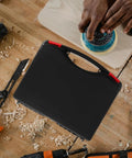 Badass Plastic Toolbox With Ergonomic Handle Designed For Mechanics And Handymen Who Demand Durability on a workbench.