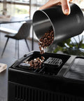 Adding coffee beans to the Dinamica Plus Fully Automatic Espresso Machine With Built In Grinder And Auto Milk Frother, 24 One-Touch Drinks