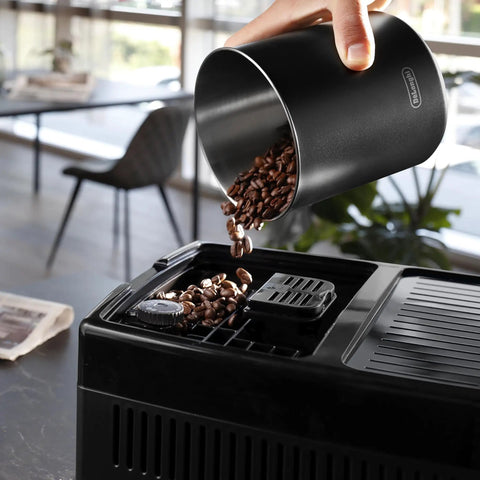 Adding coffee beans to the Dinamica Plus Fully Automatic Espresso Machine With Built In Grinder And Auto Milk Frother, 24 One-Touch Drinks