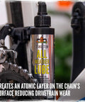 Side view of BananaSlip Tungsten All Weather Lube For Road Mountain Race And EBike Use Wax Based Water Resistant Dry Formula Biodegradable Lubricant In 50ml Bottle on a bike chain.