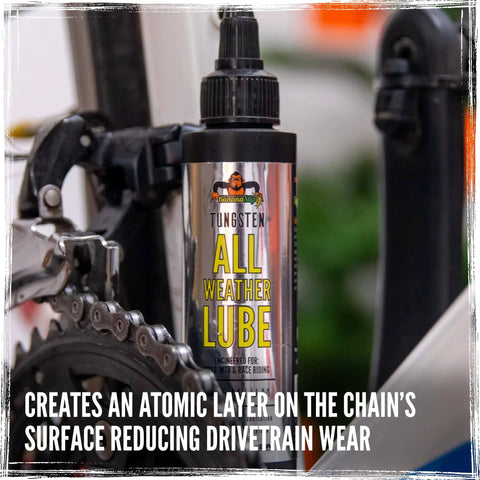 Side view of BananaSlip Tungsten All Weather Lube For Road Mountain Race And EBike Use Wax Based Water Resistant Dry Formula Biodegradable Lubricant In 50ml Bottle on a bike chain.