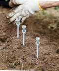 Side view of metal spikes penetrating soil, part of Heavy Duty Lawn Aerator Shoes With Metal Spikes For Deep Soil Aeration And Lawn Health Ten Pack Reusable Grass Shoes For Easy Yard Maintenance Durable Spike Boots Built To Promote Healthier Grass outdoors