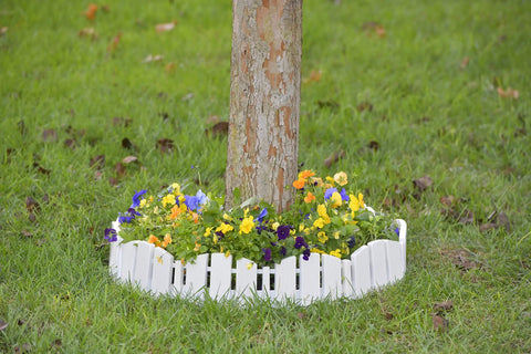 No-Dig Landscape Edging Kit With Anchoring Spikes, 4.5 Inch Tall White Wood-Look Garden Border around tree with flowers