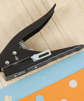 Heavy Duty 15 mm Round Hole Punch Tool For Paper, showing spring-loaded design on wooden background, used for craft and office projects.