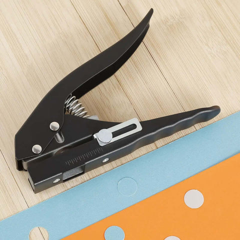Heavy Duty 15 mm Round Hole Punch Tool For Paper, showing spring-loaded design on wooden background, used for craft and office projects.