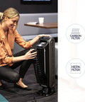 Woman adjusting No Nonsense 4 Stage Hospital Grade Filtration Air Purifier With True HEPA For Small Rooms 100 To 200 Sq Ft Ultra Quiet