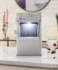 Legit Nugget Ice Maker, Portable Countertop Pellet Ice Machine in stone grey with pellet ice and drink on kitchen counter.