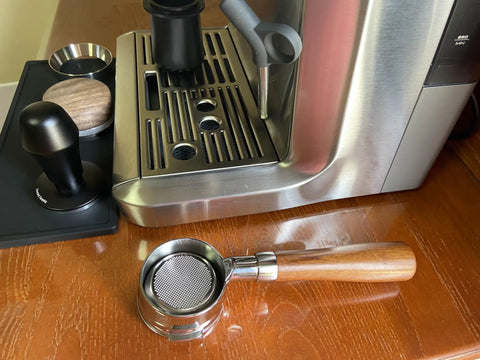 58Mm Bottomless Portafilter With Wooden Handle Compatible With Breville Espresso Machines BES900XL BES920XL BES980XL BES990BSS on wooden table.