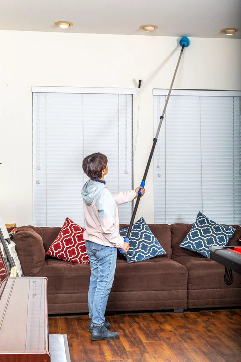 Person using a Six Foot Telescoping Extension Pole With Aluminum Shaft And EVA Grip Flip Lock Adjustable Sections for ceiling cleaning