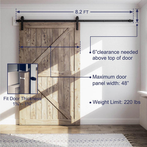Eight Point Two Foot Sliding Barn Door Hardware Kit With Smooth Quiet Track Easy To Install Includes Step By Step Installation Instructions Fits Forty Eight Inch Wide Door Panel J Shape Hanger Beefy Alloy Construction With Black Powder Coat shown installed on wooden door in room.