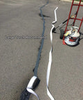 Pro Grade Premium Asphalt Crack Sealer Tape For Parking Lots Rubberized Hot Filler Joint Sealant Waterproof 4 Inch By 50 Foot Black being applied on pavement with torch