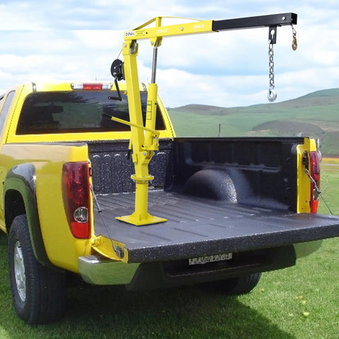 Heavy Duty Truck Bed Hoist With Hand Winch Pickup Jib Crane Hydraulic Extendable Boom Built Tough As Nails Rated Up To Two Thousand Pounds For Zero Stress Lifting in a yellow pickup truck bed.