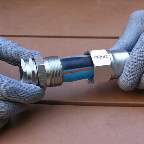 Hands using Heavy Duty 3/4 Inch Garden Hose Repair Kit With Stainless Steel Male And Female Ends, Lead Free Barb Water Hose Connectors