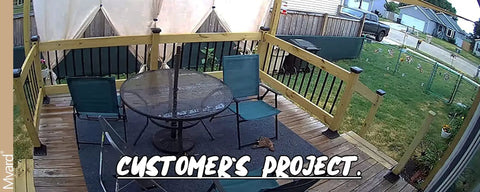 Outdoor decking area with railing, chairs, and table, showcasing finished project with Beefy Aluminum Deck Post Base Cover Flange.