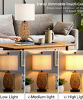 Rattan Table Lamp With Touch Control 3 Way Dimmable Bedside Light For Bedroom And Living Room Cozy Wicker Nightstand Lamp With USB Ports And AC Outlet LED Bulb Included Easy Tap To Dim on a wooden table in living room with dimmable lighting settings.