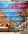 Living room with colorful graffiti wallpaper featuring blue, pink, and orange hues, on wall by stairs, showcasing Peel And Stick Graffiti Wallpaper Roll 144 Inch Wide By 100 Inch High Self Adhesive Colorful Wall Mural For Living Room Decor Easy To Align With Lined Panels And Four Tenths Inch Overlap.