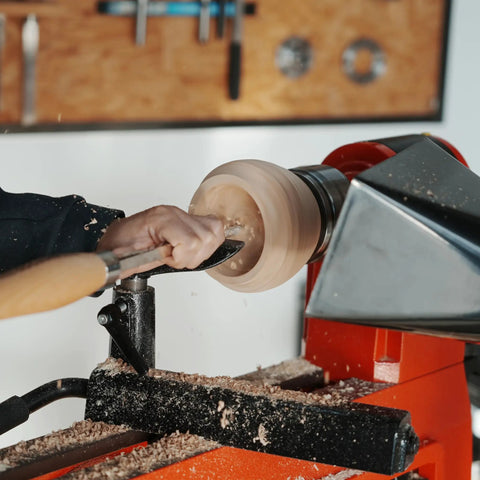 Heavy Duty Woodturning Hollowing Tool With Replaceable Carbide Tipped Round Blade And Solid Beech Handle used for shaping a wooden bowl.