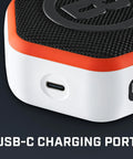 Close-up of USB-C charging port on Wingman Mini GPS Speaker With Audible Distances, Ultra Portable Bluetooth Golf Speaker On The Go, Waterproof IPX7, 10 Hour Battery, Magnetic Cart Mount, Built In Microphone For Calls, Carabiner Clip, Orange.
