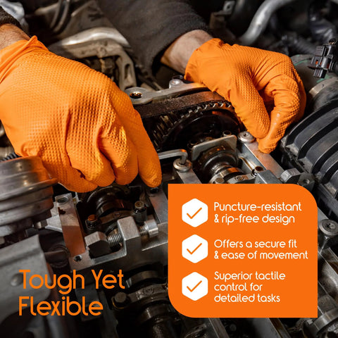 Orange disposable gloves worn by a mechanic working on an engine