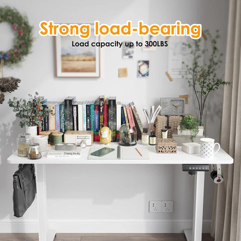 Electric Standing Desk With Four Memory Presets And No Sweat Height Adjustment In White, with books and accessories organized on top.