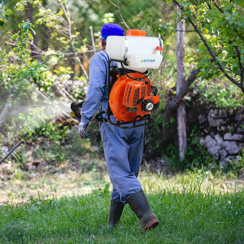 Person using Beastly Heavy Duty Backpack Fogger Sprayer With 63cc 3HP Engine 20L Tank Long 39 Foot Spray Reach in garden