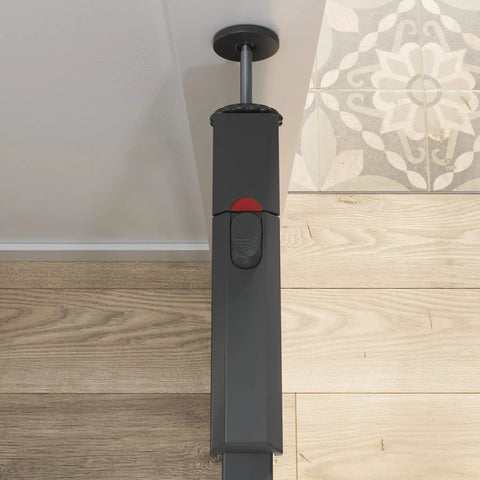 Close-up of pressure-mounted mechanism of Walk Through Metal Baby Gate For Doorways, Adjustable From 29.5 To 40.5 Inches, Gray.