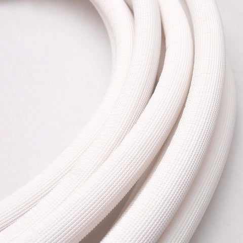Close-up of white insulated copper coil line tubing for HVAC refrigerant, 1/4" copper with 1/2" insulation