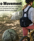 Cyclist wearing a Mountain Bike Hydration Pack With 3L Bladder And 10L Storage For Trail Rides, lumbar support, charcoal color.
